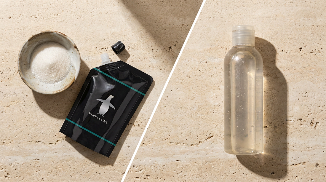 KinkiLube powder pouch beside a bottle of regular lube on travertine