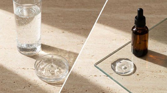 Glass of water vs silicone dropper bottle on travertine